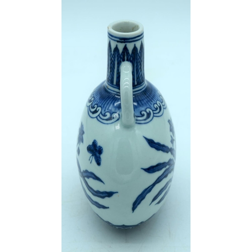 2670 - A small Chinese  blue and white moon flask decorated with butterfly and  foliage. 19cm.