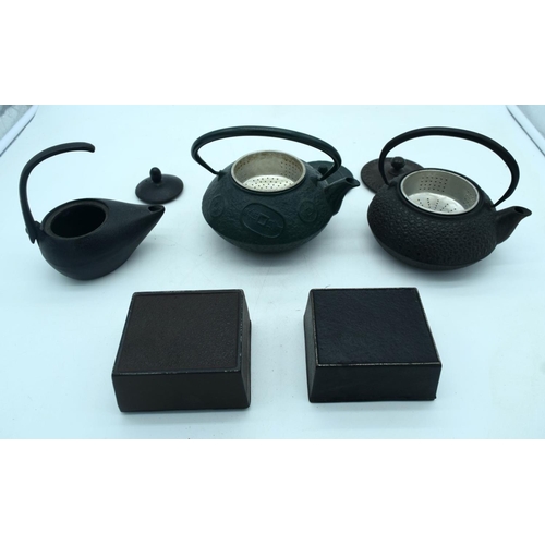 2680 - Three heavy cast iron  metal Japanese tea pots together with two boxes . 18 x 9 cm (5).