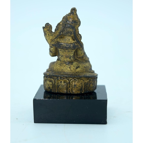 2690 - A small Chinese Tibetan gilt bronze Buddha mounted on a base. 6cm.