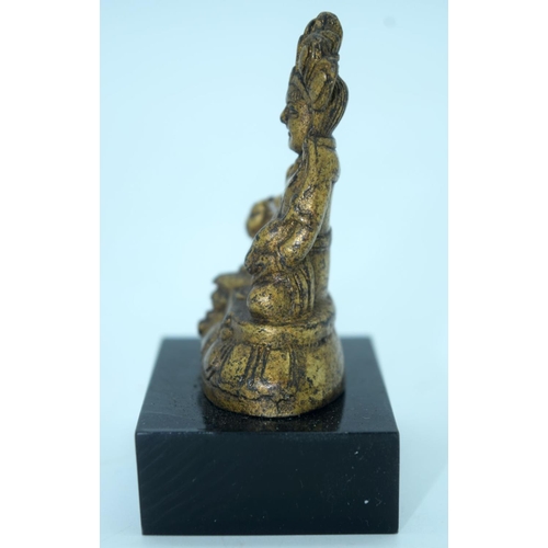 2692 - A small Chinese Tibetan gilt bronze Buddha mounted on a base. 6cm.