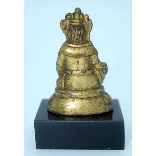 2692 - A small Chinese Tibetan gilt bronze Buddha mounted on a base. 6cm.