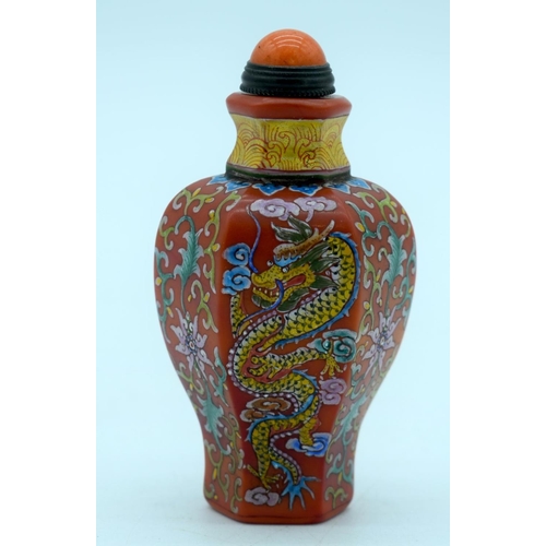 2695 - A Chinese red ground snuff bottle with a dragon and foliage. 9cm.