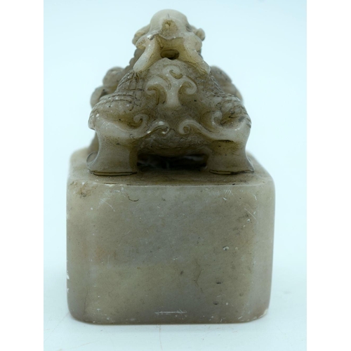 2699 - A carved hard stone seal in the form of a beast 8cm.