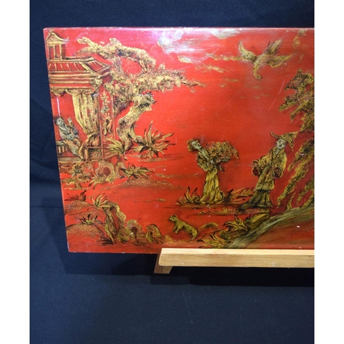 2752 - A Chinese lacquered wooden panel depicting people in a rural  pursuits 41 x 76cm..