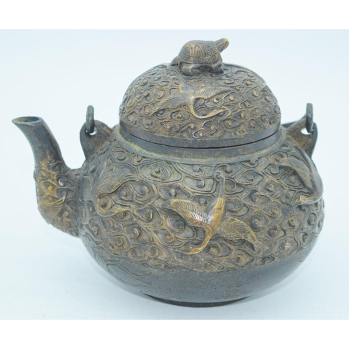 2766 - A Chinese bronze heavily embossed Tea pot 13 x 18cm.