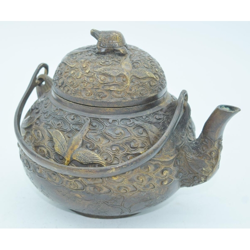 2766 - A Chinese bronze heavily embossed Tea pot 13 x 18cm.