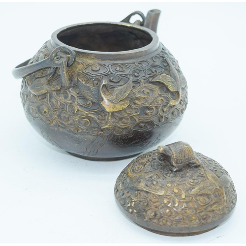 2766 - A Chinese bronze heavily embossed Tea pot 13 x 18cm.