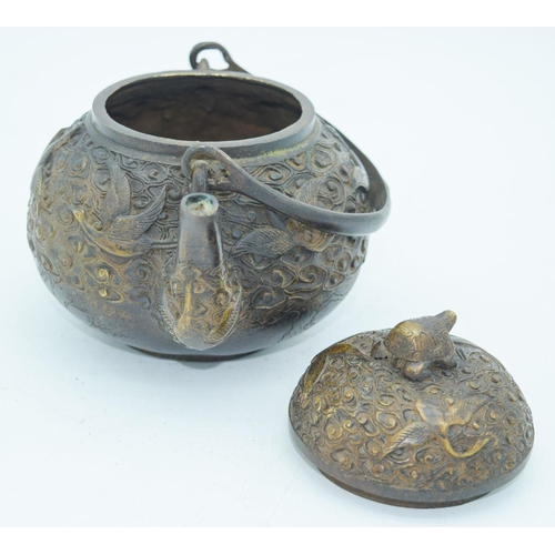 2766 - A Chinese bronze heavily embossed Tea pot 13 x 18cm.