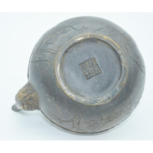 2766 - A Chinese bronze heavily embossed Tea pot 13 x 18cm.