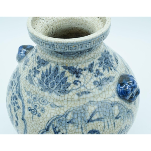 2785 - A Chinese Crackle glaze vase with lions head handles decorated with figures and foliage 27cm