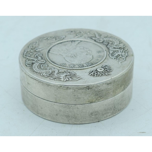 2798 - A Chinese small white metal coin  box embossed with dragons 7.5 cm.