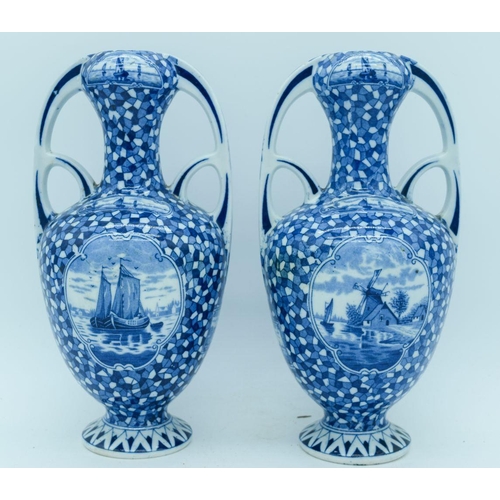 2822 - A pair of Delft twin handle vases painted with scenes of Dutch barges. 25cm.