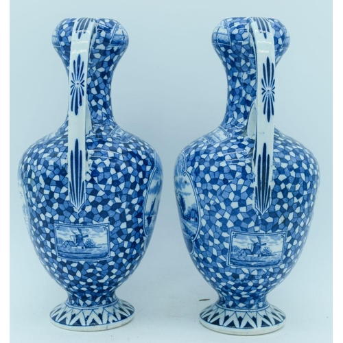 2822 - A pair of Delft twin handle vases painted with scenes of Dutch barges. 25cm.