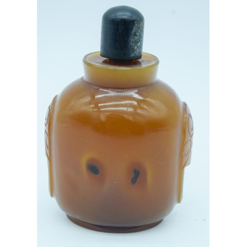 2823 - An carved agate snuff bottle with stopper 9cm.