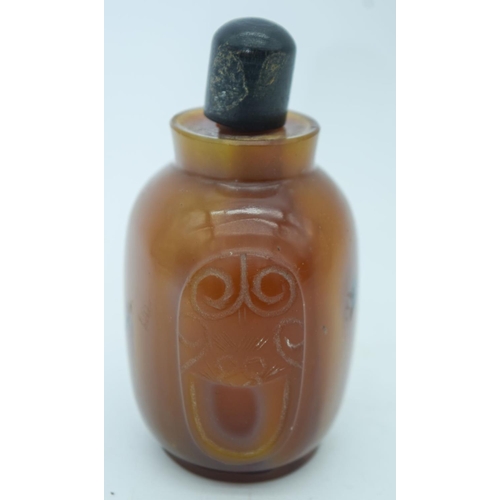 2823 - An carved agate snuff bottle with stopper 9cm.