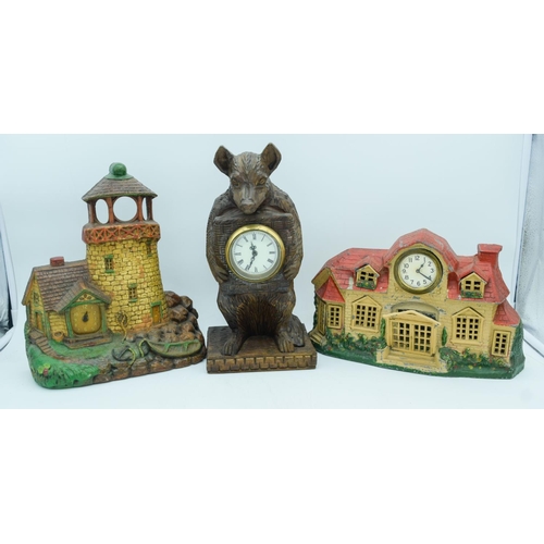 2830 - A wooden American art clock of a light house together with a cast iron clock and a bear clock.