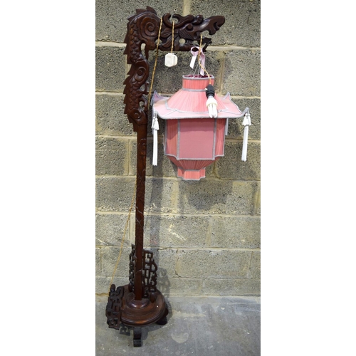 2869 - A hardwood oriental lamp stand in the shape of a dragon 164 cm.