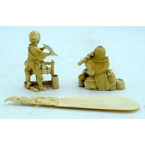 2919 - Two Japanese Ivory Okimono , a seated male holding a fan, a standing woman and a carved shoe horn 17... 