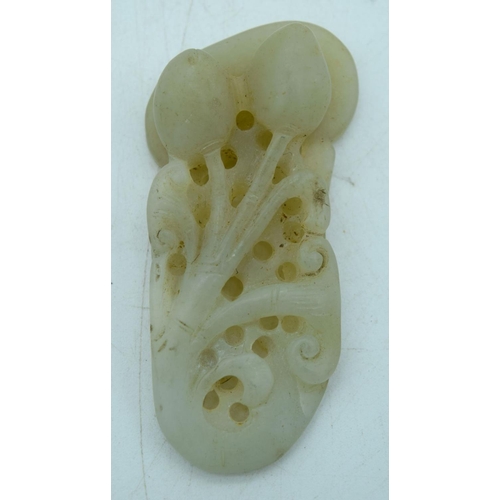 2932 - A carved jade pendant in the shape of a flower and lion pendant 7.5 cm.