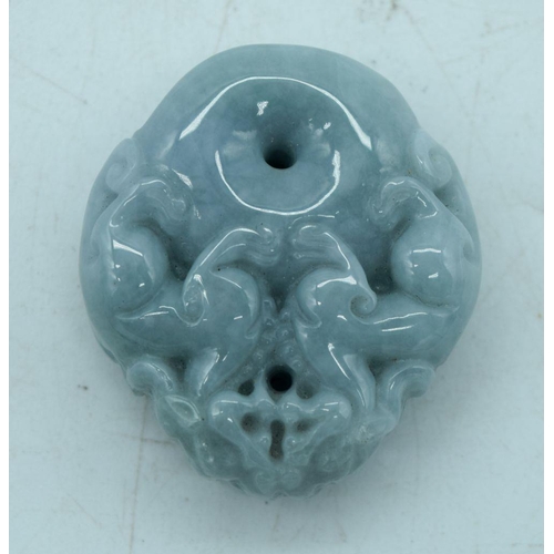 2932 - A carved jade pendant in the shape of a flower and lion pendant 7.5 cm.