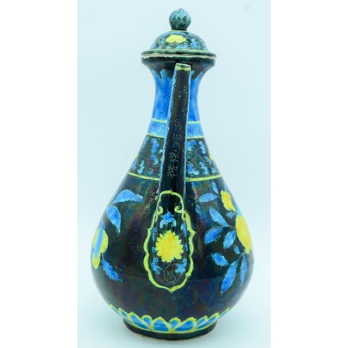 2941 - A Chinese wine pot  decorated with yellow and blue flowers in relief 30cm.