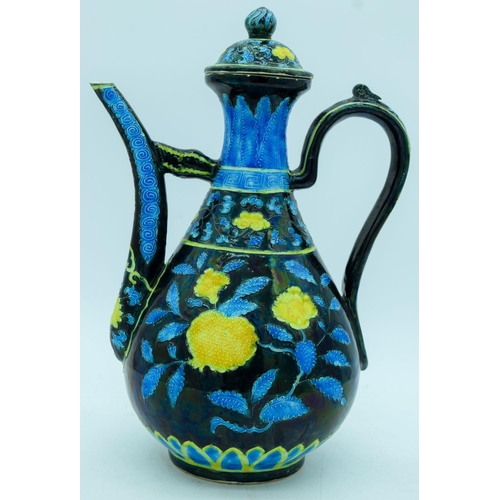 2941 - A Chinese wine pot  decorated with yellow and blue flowers in relief 30cm.