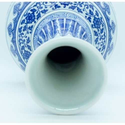 2947 - A Chinese blue and white vase decorated with lotus flower. 39cm.