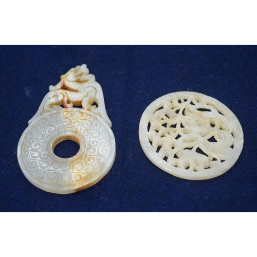 2963 - Two Jade pendants decorated with a dragon and a lion 8.5cm.