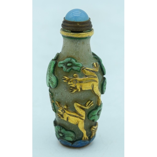 2964 - Chinese Peking Glass snuff bottle decorated in relief with lotus and frogs  8 cm.