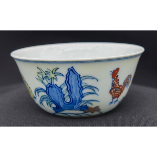 2983 - A Chinese tea bowl decorated with a chicken 8 x 3.5 cm.