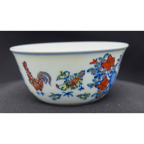 2983 - A Chinese tea bowl decorated with a chicken 8 x 3.5 cm.