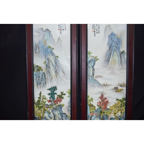 3005 - A pair of Hongmu framed Chinese porcelain panels decorated with a Famille verte landscape 82 x 29cm ... 