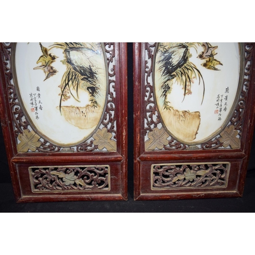 3007 - A Framed pair of Chinese porcelain panels decorated with birds and foliage 80 x 37cm. (2)