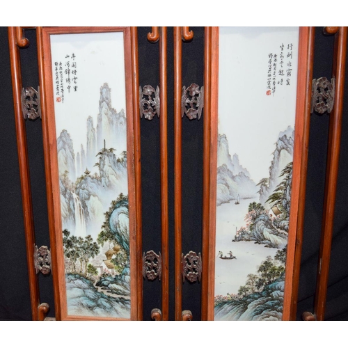 3008 - A framed pair of Famille Verte porcelain panels decorated with a landscape 68 x 28 cm (2)