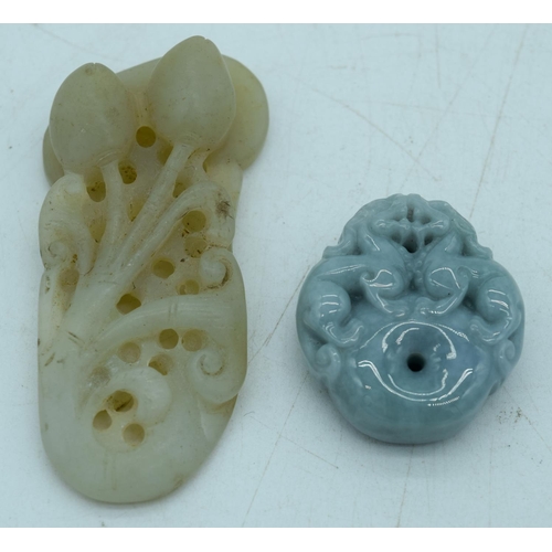 2932 - A carved jade pendant in the shape of a flower and lion pendant 7.5 cm.