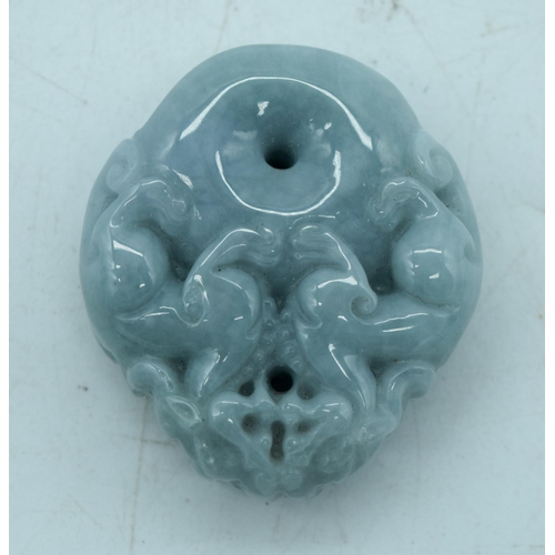 2932 - A carved jade pendant in the shape of a flower and lion pendant 7.5 cm.