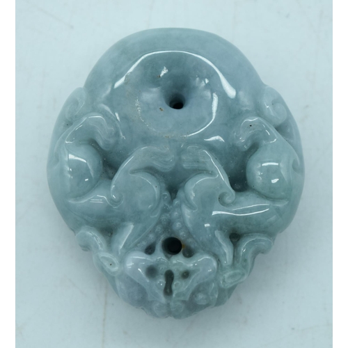 2932 - A carved jade pendant in the shape of a flower and lion pendant 7.5 cm.