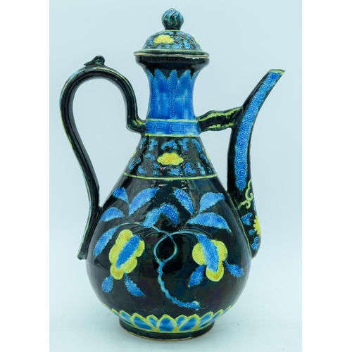 2941 - A Chinese wine pot  decorated with yellow and blue flowers in relief 30cm.