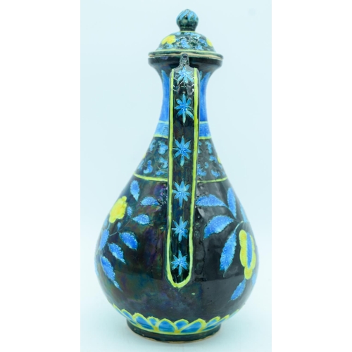 2941 - A Chinese wine pot  decorated with yellow and blue flowers in relief 30cm.