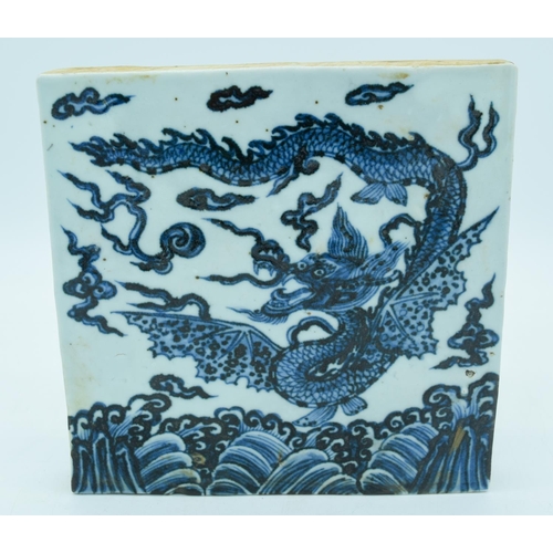 2982 - A Chinese blue and white temple tile decorated with a dragon 20 x 20cm.