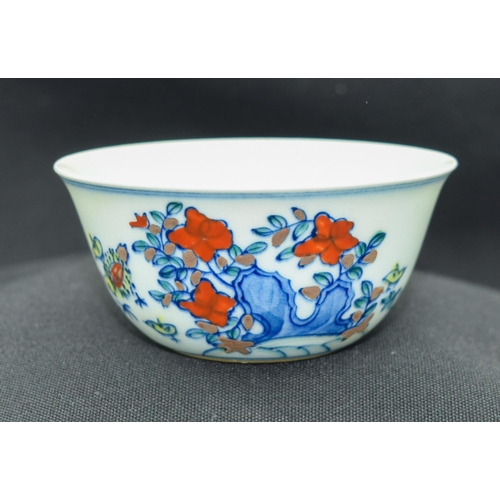 2983 - A Chinese tea bowl decorated with a chicken 8 x 3.5 cm.