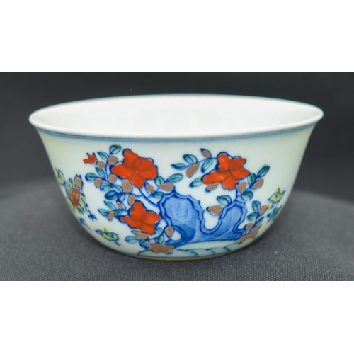 2983 - A Chinese tea bowl decorated with a chicken 8 x 3.5 cm.