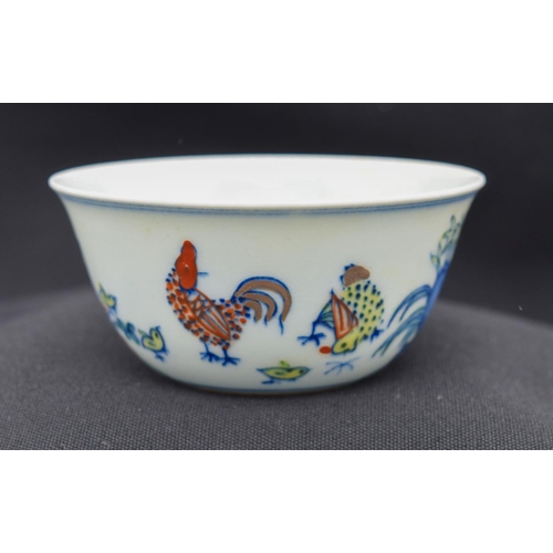 2983 - A Chinese tea bowl decorated with a chicken 8 x 3.5 cm.