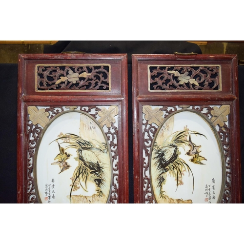 3007 - A Framed pair of Chinese porcelain panels decorated with birds and foliage 80 x 37cm. (2)