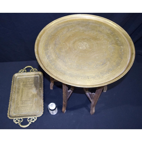 3013 - A large Middle Eastern embossed  brass tray on a stand together with another 58cm (2).