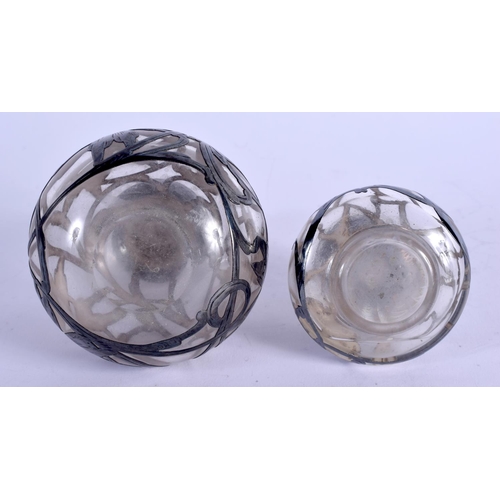 935 - TWO SILVER OVERLAID GLASS SCENT BOTTLES. Largest 11 cm high. (2)