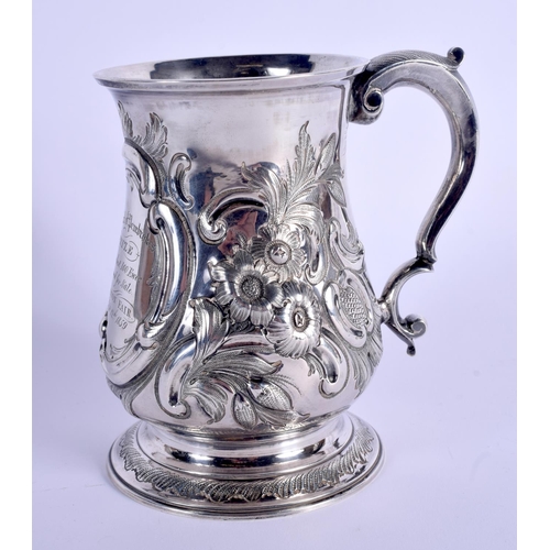 784 - AN ANTIQUE SILVER MUG decorated with foliage. London 1828. 339 grams. 13 cm high.