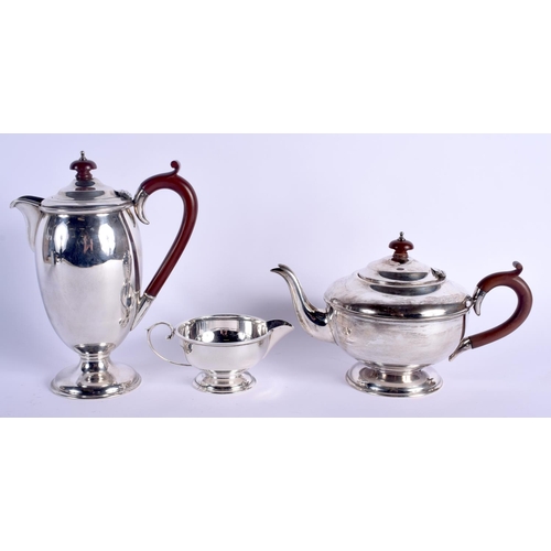 794 - AN ART DECO SILVER THREE PIECE COFFEE SET. Birmingham 1930. 1050 grams. Largest 22 cm high. (3)