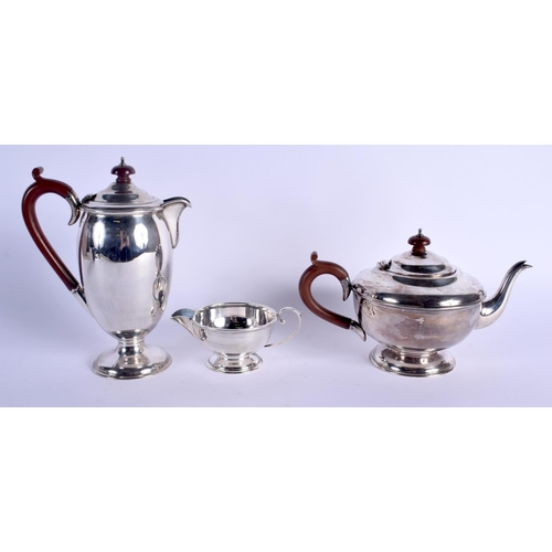 794 - AN ART DECO SILVER THREE PIECE COFFEE SET. Birmingham 1930. 1050 grams. Largest 22 cm high. (3)