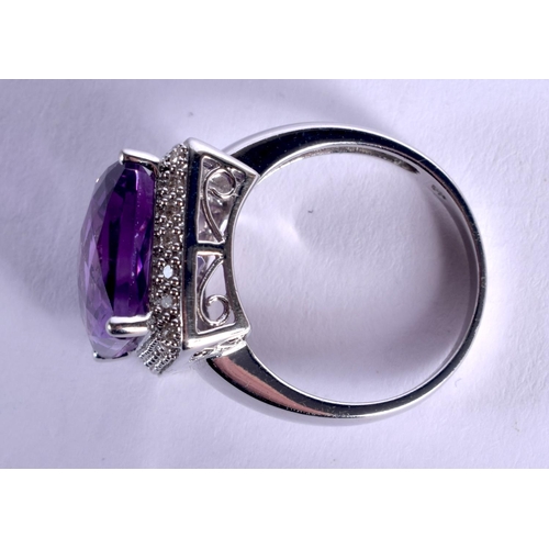 979 - A 14CT GOLD DIAMOND AND AMETHYST RING.7 grams. O.